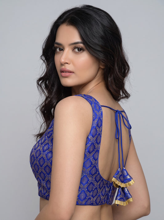 SurpriseLadies festive blue blouse with gold brocade pattern, sleeveless design, and back tie-up with tassels.
